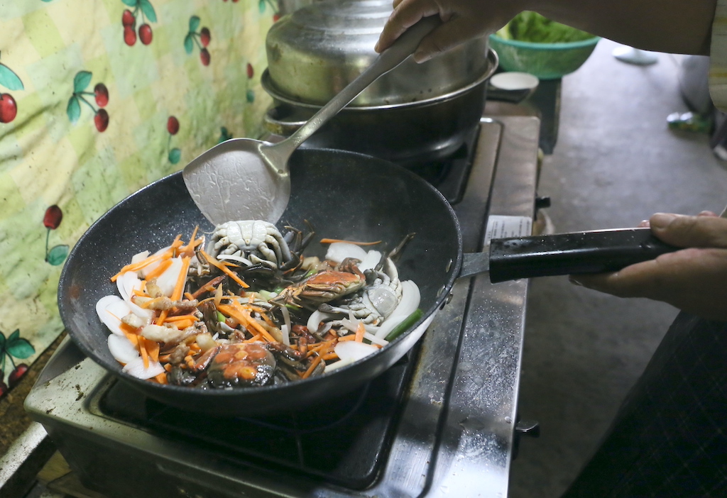 豬五花肉炒、紅蘿蔔、洋蔥、蔥段炒香之後，就可以把備用的毛蟹放回鍋裡一起炒。